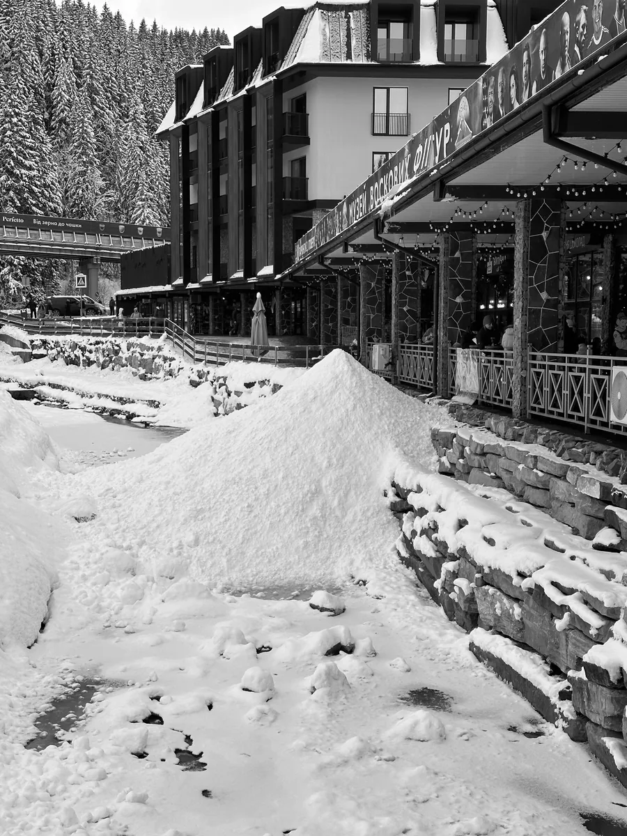 A heap of ice shavings from the skating rink, dumped by the river at Bukovel
